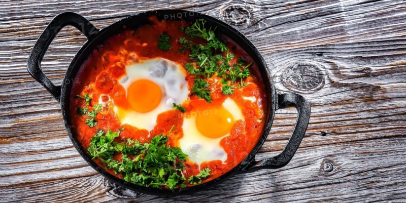 Shakshouka dish in a cast iron pan