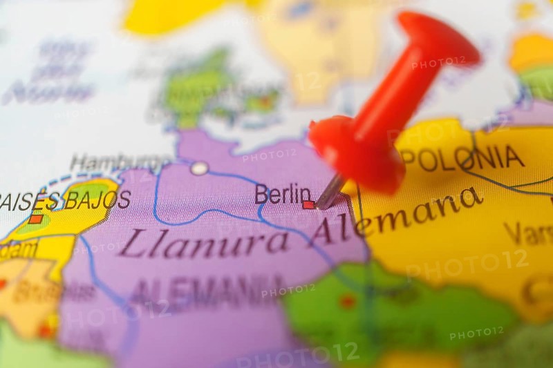 Berlin marked with a red thumbtack on a map with an out-of-focus background