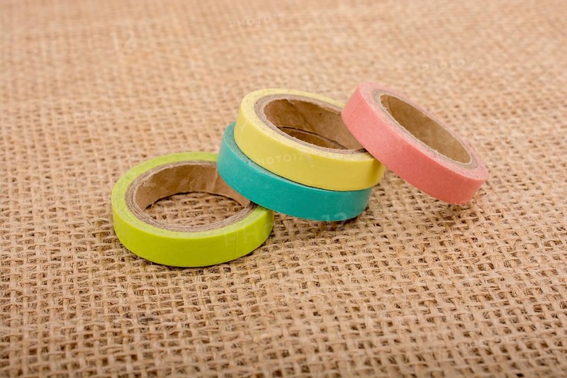 Colorful insulating adhesive tape on linen canvas background
