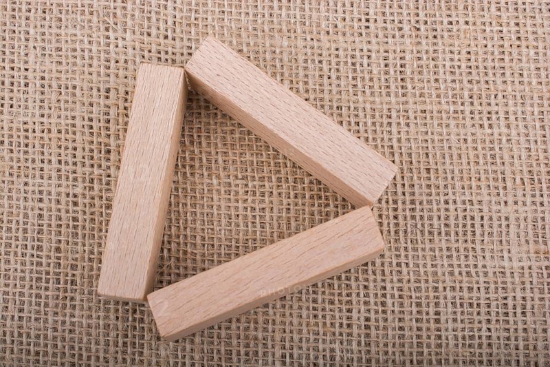 Wooden domino on a linen canvas background