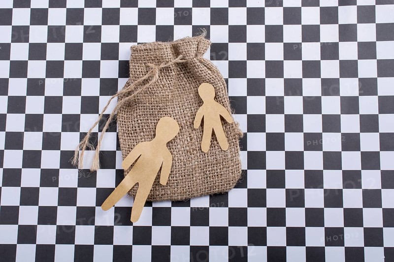 Man shape cut out of paper on canvas sack