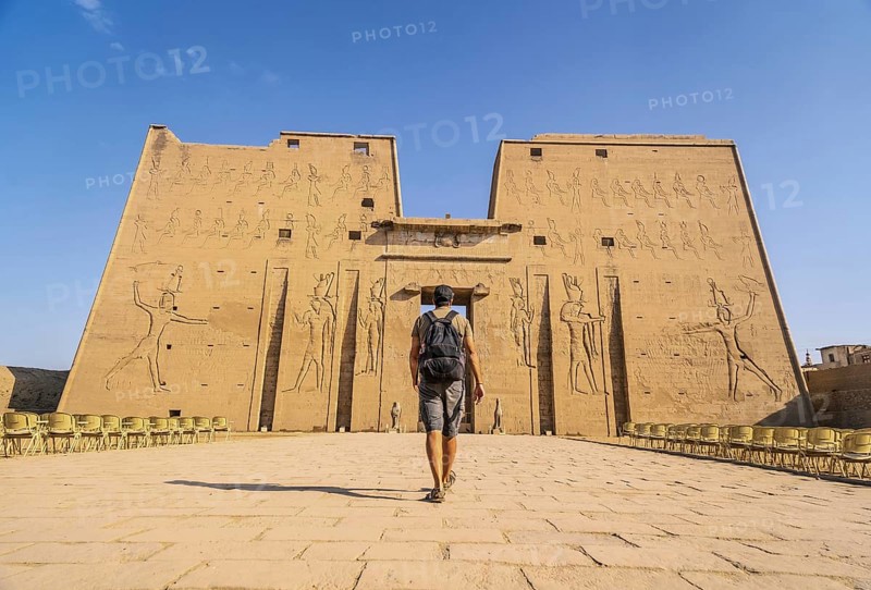 A young tourist entering the Temple of Edfu in the city of Edfu
