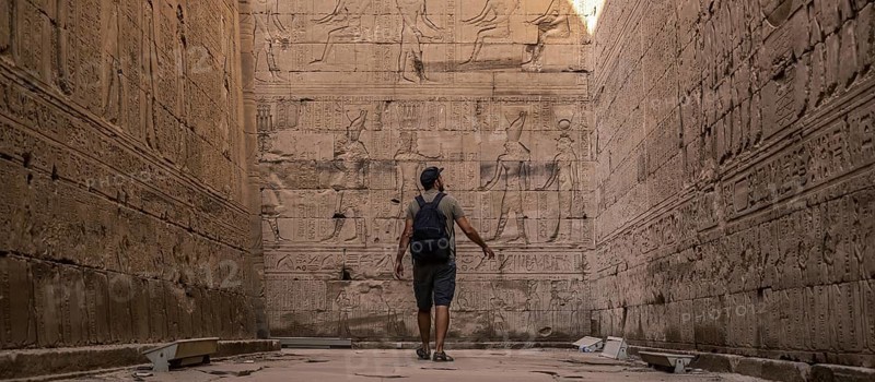 A young tourist visiting the beautiful temple of Edfu in the city of Edfu