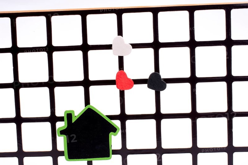 Green house on a grill with a few hearts