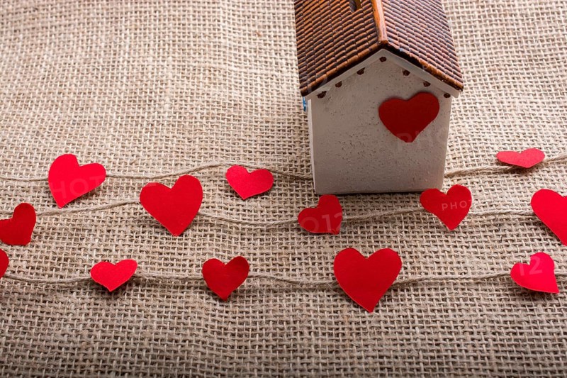 Heart shaped icons and paper house on linen threads
