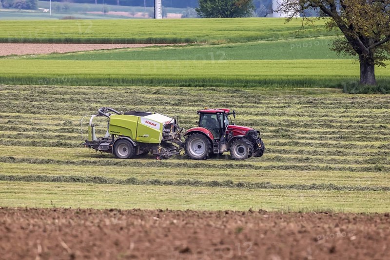 Farmer with tractor in a field in spring