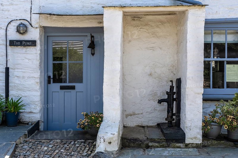 Historic 18th century cottage with cast iron swan pump