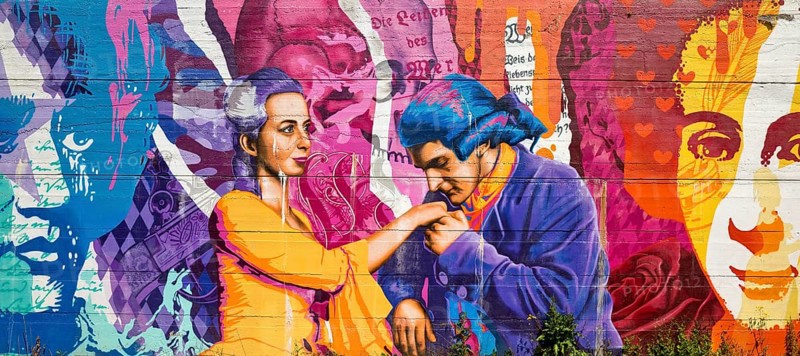 Brightly coloured graffiti on Lottehaus with Charlotte Buff and Johann Wolfgang von Goethe