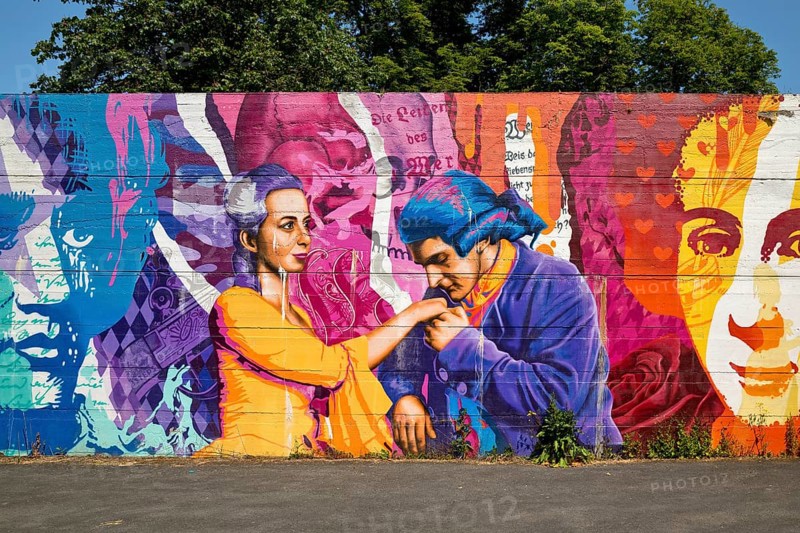 Brightly coloured graffiti on Lottehaus with Charlotte Buff and Johann Wolfgang von Goethe