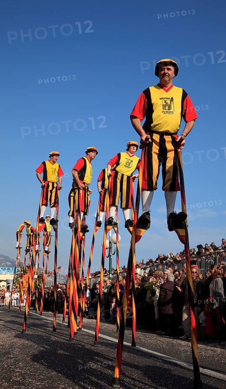 Stilt walkers in the street parade in Menton