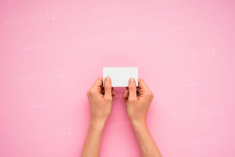 Person hands holding little paper
