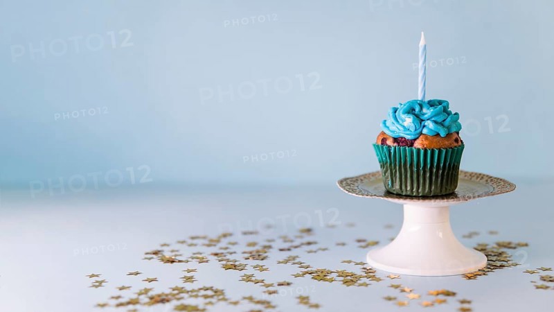 Candle cupcake cakestand against blue background