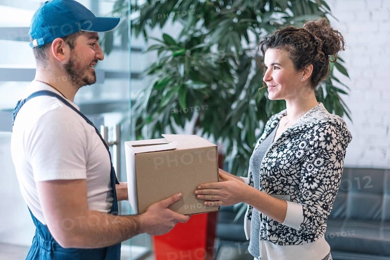 Side view woman taking parcel from deliveryman