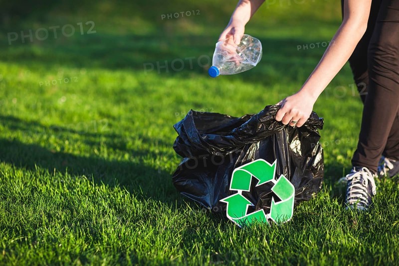 Recycle concept with woman collecting trash
