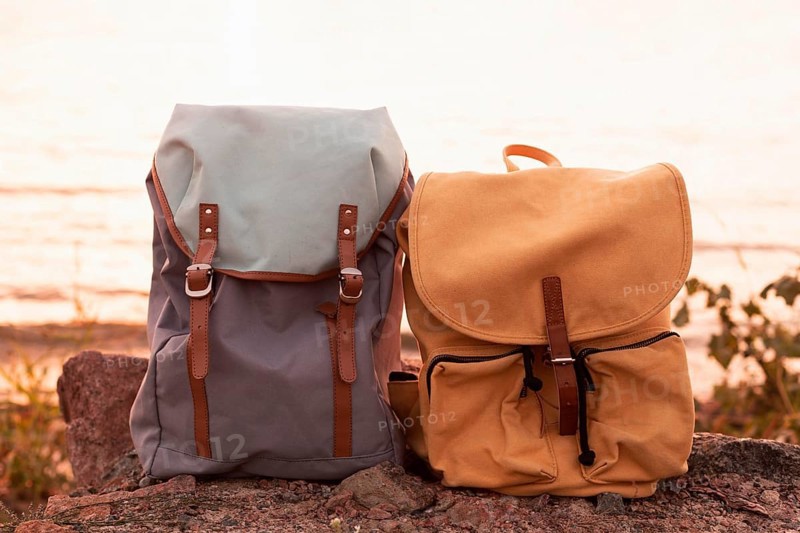 Couple backpacks rocks sunset
