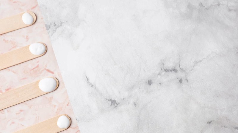 Wooden sticks with cream marble background
