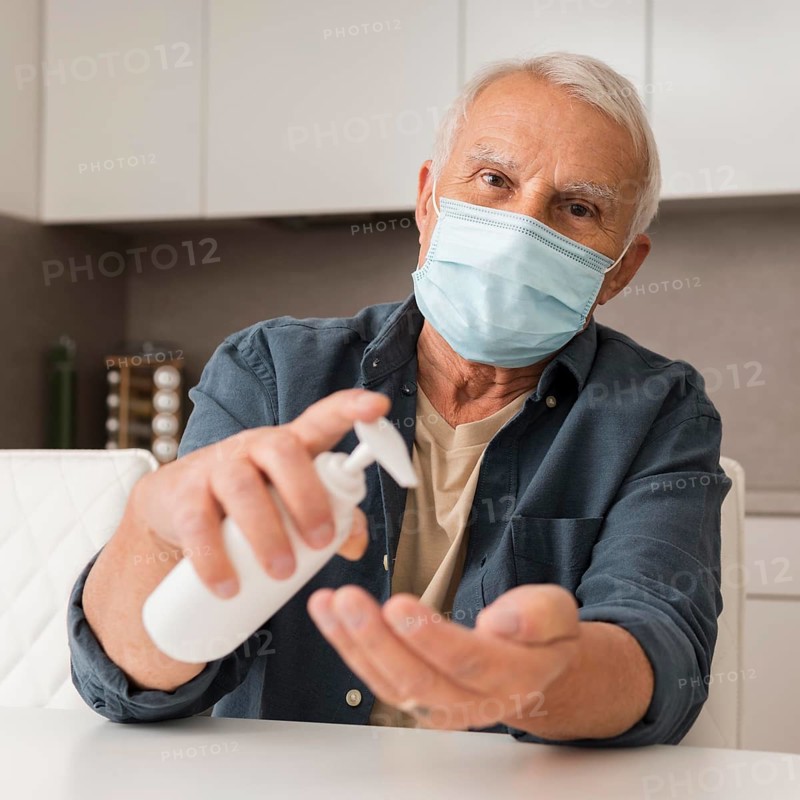 Front view man with mask disinfectant