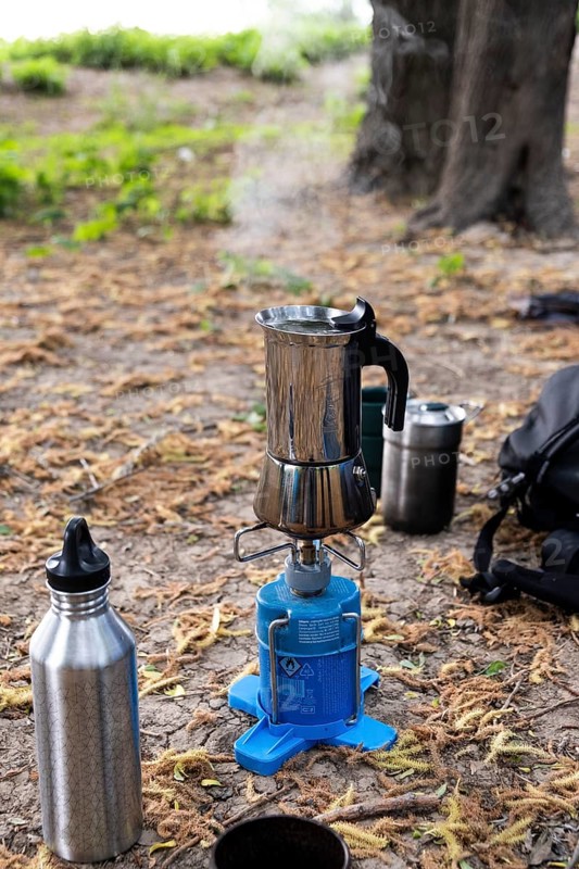 An espresso maker on a camping gas barbecue