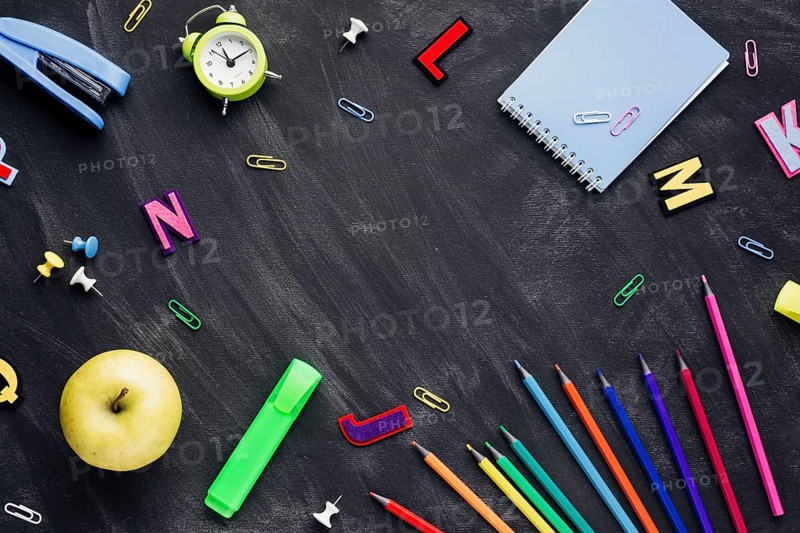 School stationery with apple alarm clock scattered blackboard