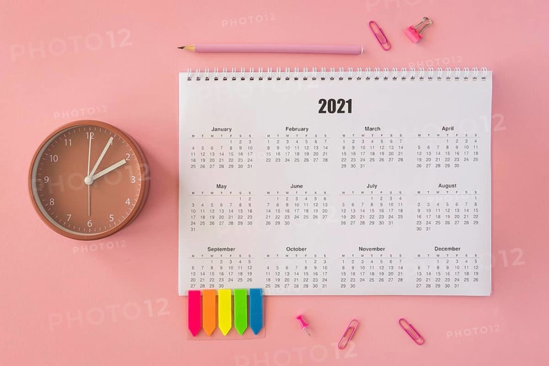 Flat lay desk calendar pink background