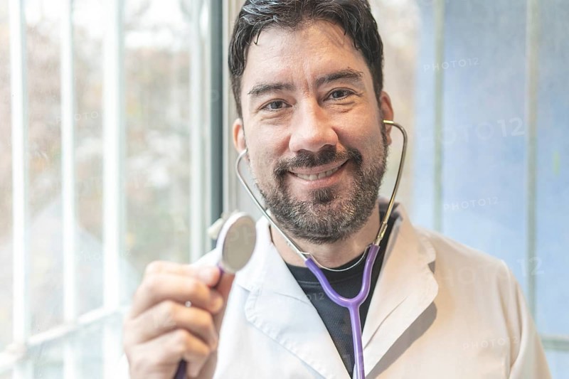 Latin cardiologist smiling at the camera