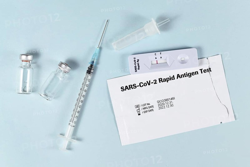 Tools to fight Corona Virus pandemic including rapid antigen test and vaccine vials with syringe