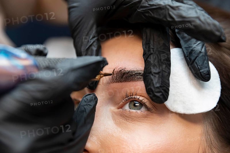 Young woman getting beauty treatment her eyebrows
