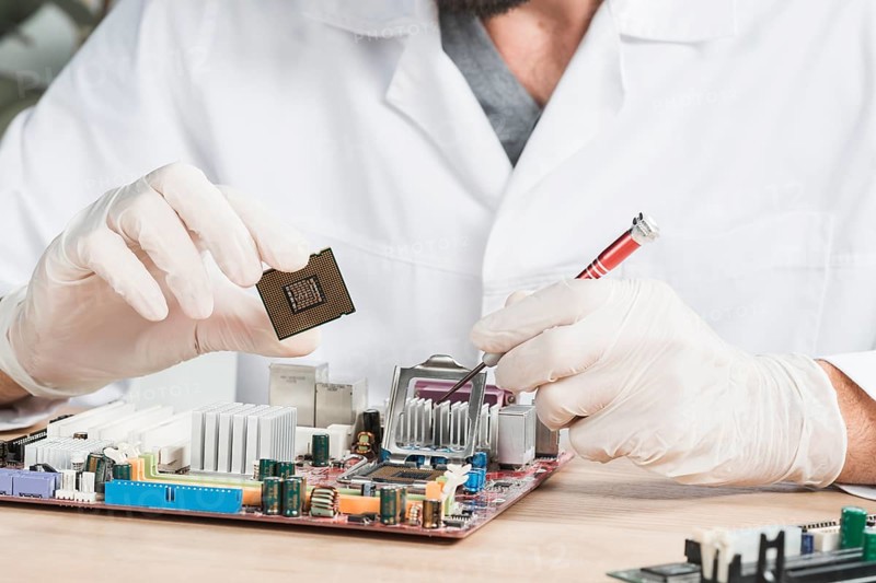 Close up male technician holding computer chip