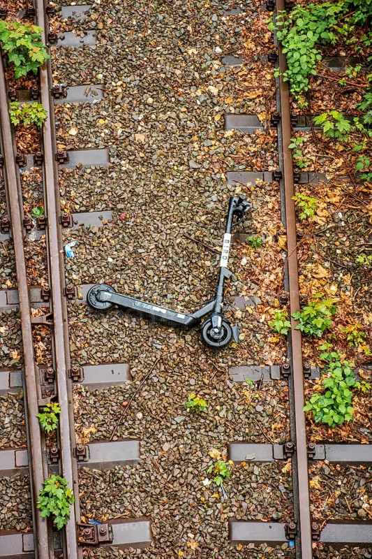 An electric scooter lies overturned between two railway tracks in Duesseldorf