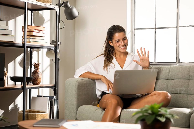 Female sitting couch laptop