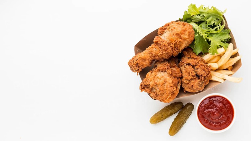 Top view fried chicken drumsticks with ketchup fries with copy space