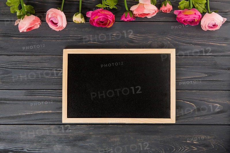 Rose flowers with big chalkboard wooden table
