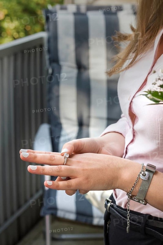 Hand of a young woman with a nice ring. Engagement. The scene on the balcony. Vertical image