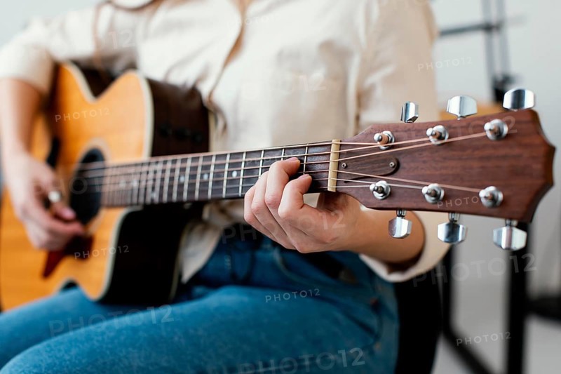 Female musician playing acoustic guitar