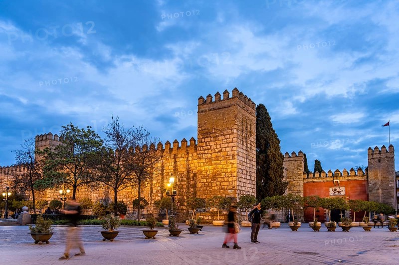 Tower and walls of the Alcazar Royal Palace at dusk