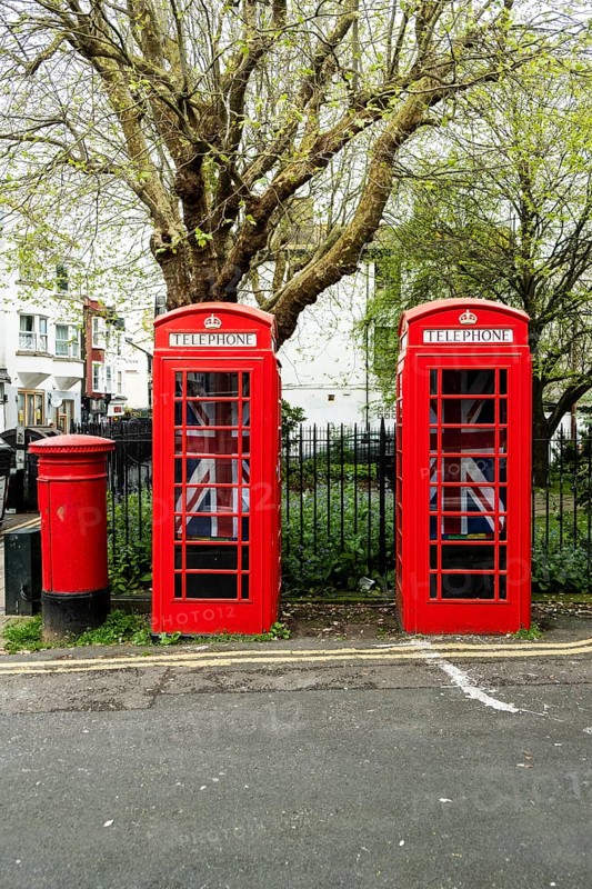 Two English red telephone boxes with Union Jack flags