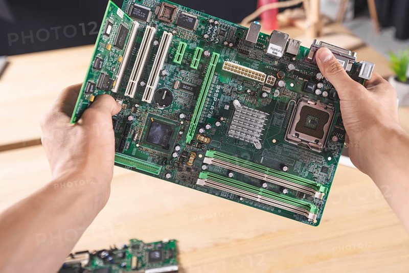 Close up it male technician holding computer mainboard