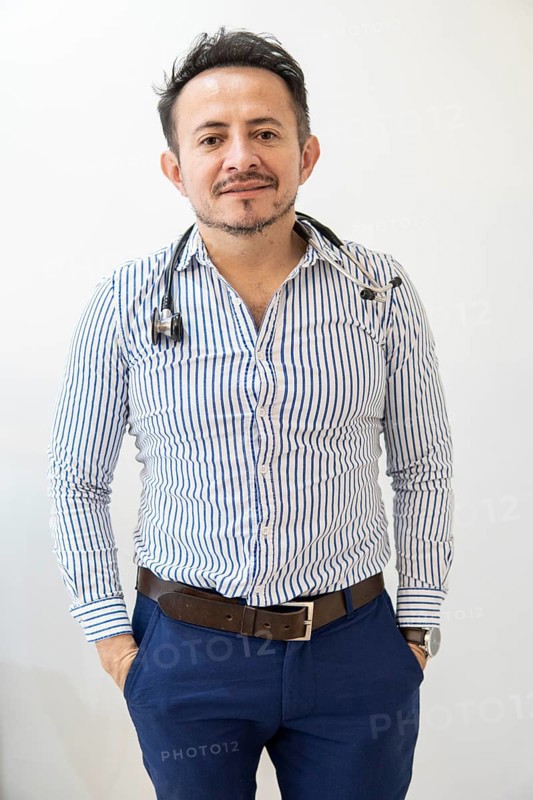 Portrait of latin doctor posing in his office