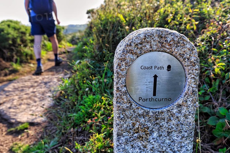 Walkers next to waymarker