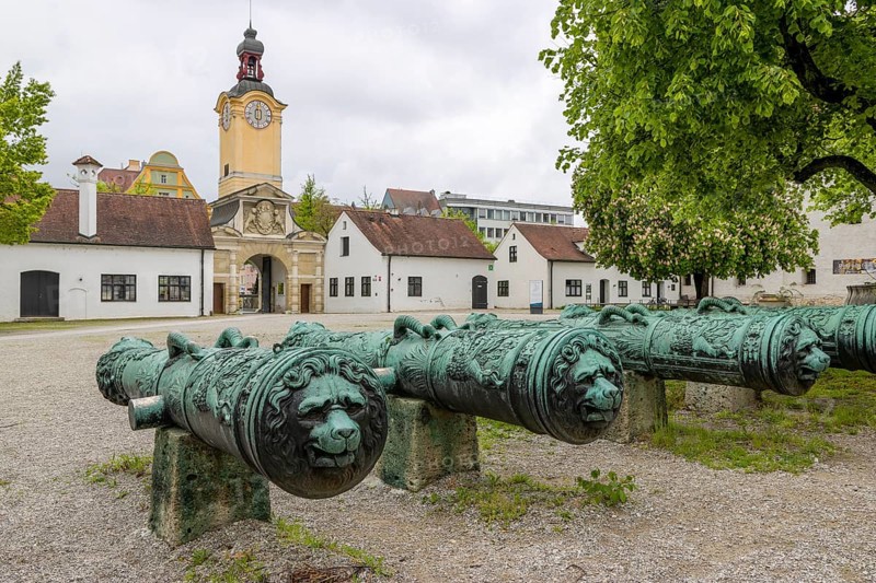 Old cannons and in the background Baroque clock tower at the entrance of the Bavarian Army Museum