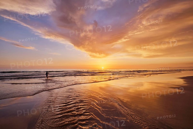 Atlantic ocean sunset with surging waves at Fonte da Telha beach
