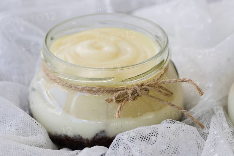 Rope tied around lemon curd jar white lace fabric