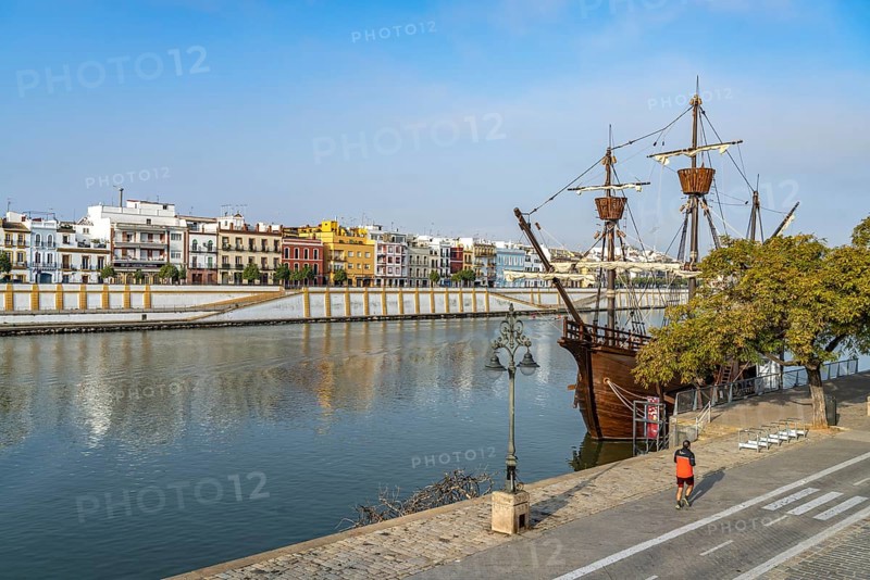 Replica of the Nao Victoria 500 and the colourful houses of the Triana district on the Guadalquivir River