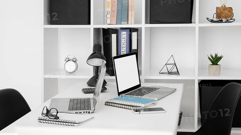 Office desk surface with two laptops