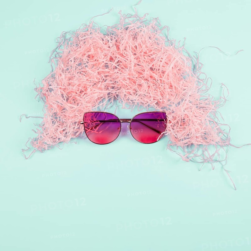 Pink shredded paper wig sunglasses mint background