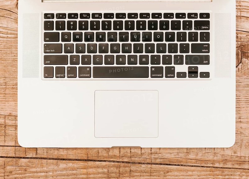 Topview laptop keyboard wooden background