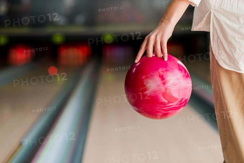 Person holding red bowling ball