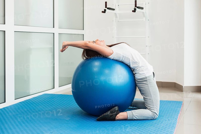 Female patient using exercise ball