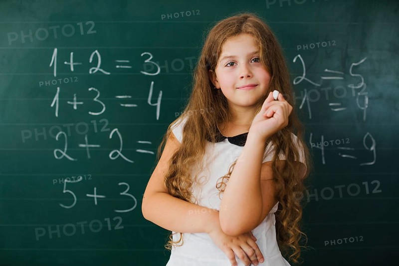 Schoolgirl smiling blackboard class