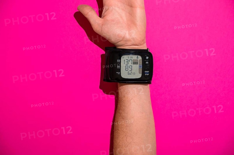 Blood pressure monitor on a man's trading joint